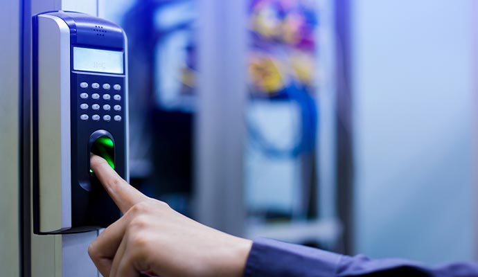 A person using a fingerprint scanner to unlock a door