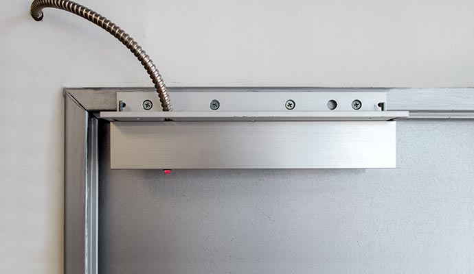 A close-up view of an overhead door closer