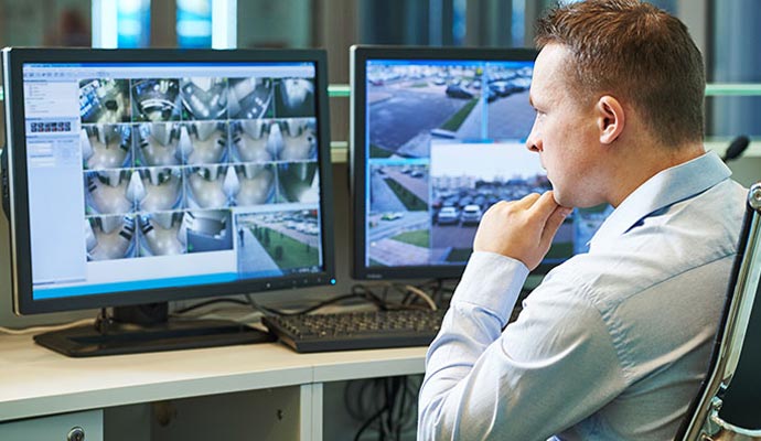 person monitoring CCTV footage