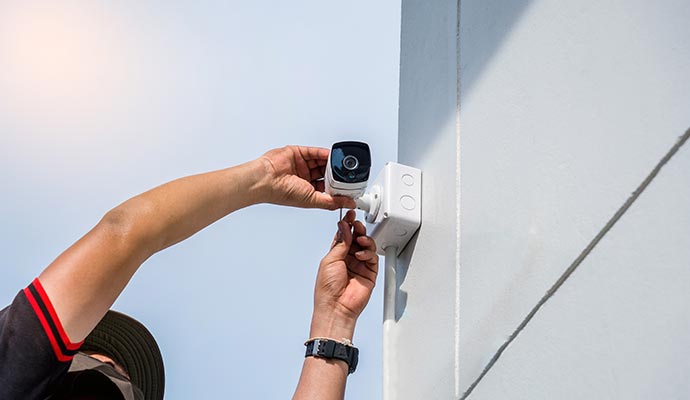 person installing outdoor camera