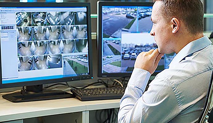 Person monitoring video surveillance camera footage