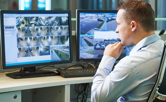 Person monitoring video surveillance footage