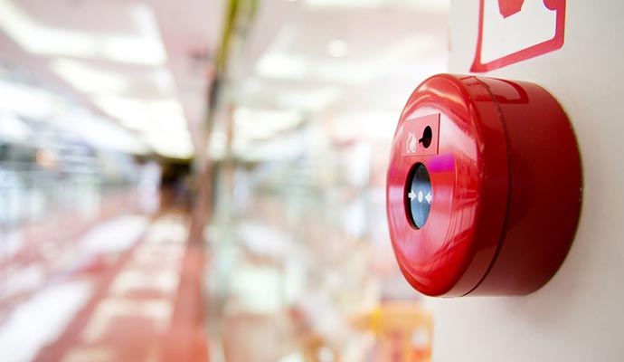 A red fire alarm button on a wall